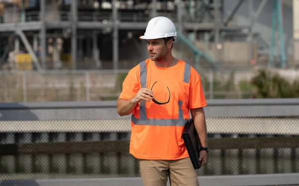 image of engineer man at construction site. engineer man at construction site. engineer man at construction site wearing hardhat. engineer man at construction site outdoor.