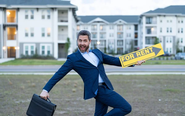 rent house with happy renter adviser man outdoor. photo of renter adviser man with for rent sign. rent property by renter adviser man. renter adviser man hold board for rent sign.