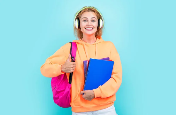 photo of cheerful school woman student hold backpack. school education of woman student. school woman student isolated on blue background. school woman student at studio.