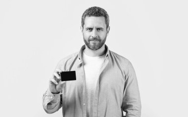 smiling man show business debit isolated on studio background. man with business debit in studio. man holding business debit. photo of man hold business debit.