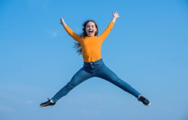 happy teen girl jump high on sky background. happiness.