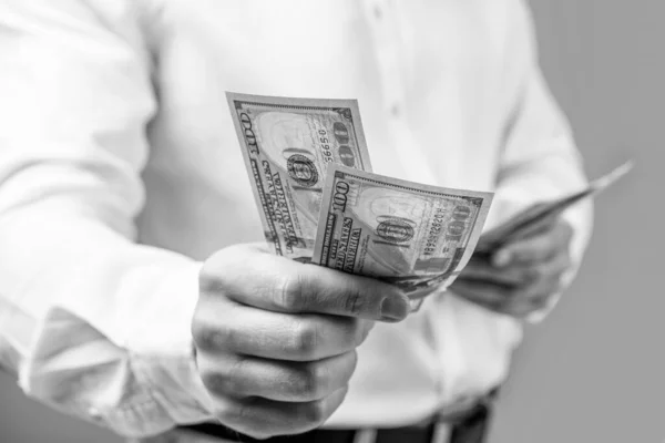 stock image paying money dollars. closeup of paying money dollars at studio. man paying money dollars. selective focus of paying money dollars.