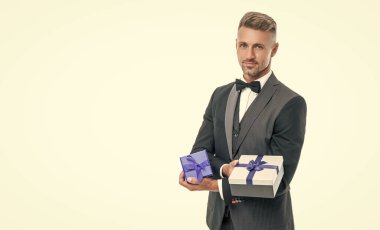 smiling man in tux with business reward box isolated on white.
