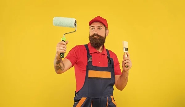 Puzzled Bearded Man Work Clothes Hold Paint Roller Brush Yellow — Stock Fotó