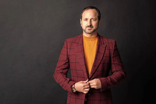 stock image menswear for mature man, copy space. photo of mature man in stylish menswear. mature man in stylish menswear isolated on black background. mature man in stylish menswear in studio.