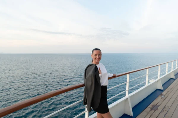 cheerful woman has business trip outdoor. photo of woman in business trip. woman has business trip on ship. woman has business trip at seascape.