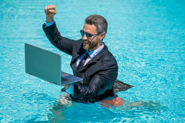 photo of man has business video call in weekend, success. man has business video call in weekend. man has business video call in weekend refreshing at pool. man has business video call in weekend