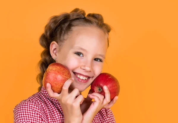 stock image cheerful child eat fruit. full of vitamin. smiling kid hold red apple. vegetarian diet. autumn harvest. happy teen girl hold apple. happy and healthy childhood. healthy food and eating. copy space.