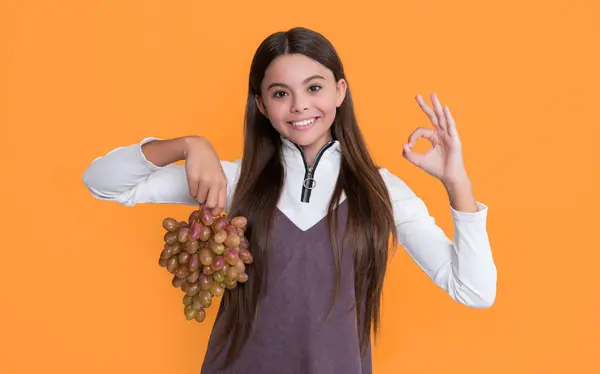 Smiling Child Holding Fresh Grapes Fruit Yellow Background — Stockfoto