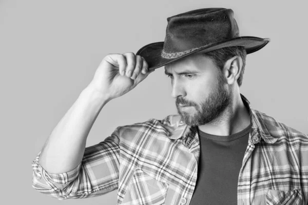west man with cowboy hat isolated on grey background. west man in cowboy hat in studio. photo of west man wearing cowboy hat. west man wear cowboy hat.