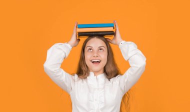 Bilgi günü. Çocuk defteri tut. Lise öğrencisiydim. Genç kız ödevlerini defterle yapıyor. Çalışma kitabıyla çalış. Şaşırmış çocuk kitap yığınını tutuyor. Okula dönüyorum. çocukluk eğitimi.