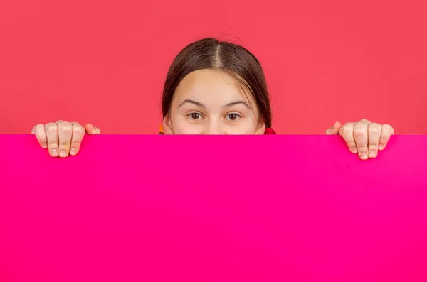 Teenie Mädchen Hinter Leerem Rosa Papier Mit Kopierplatz Für Werbung — Stockfoto