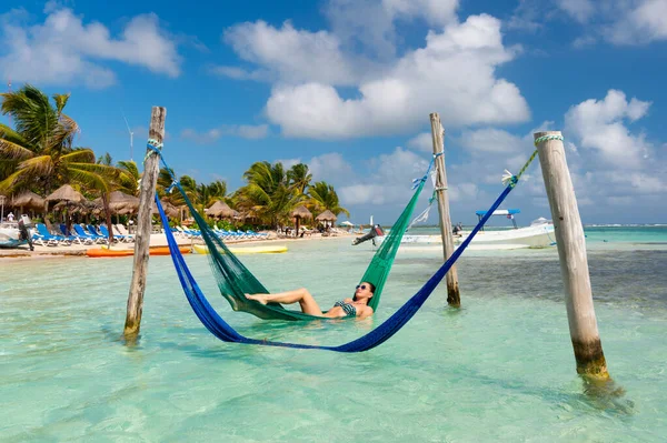 stock image woman relax at sunny summer beach on vacation. woman relax at summer beach in hammock. photo of woman relax at summer beach. woman relax at summer beach.