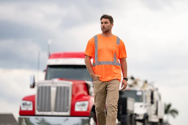 truck driver represents logistics. truck driver shows concept of logistics. truck driver represents logistics walking outdoor. image of truck driver with logistics concept.