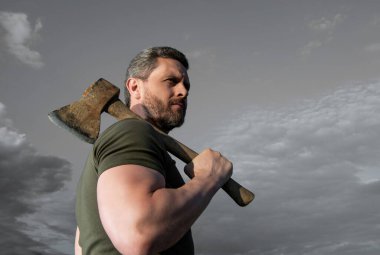 brutally man with axe. lumberjack man hold ax. brutal man on sky background.