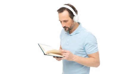 man reading elearning in headphones, advertisement. photo of man reading elearning in headphones. man reading elearning in headphones isolated on white. man reading elearning in headphones in studio.