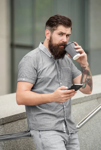 Hombre Barbudo Mensajes Texto Través Del Teléfono Móvil Mientras Bebe — Foto de Stock