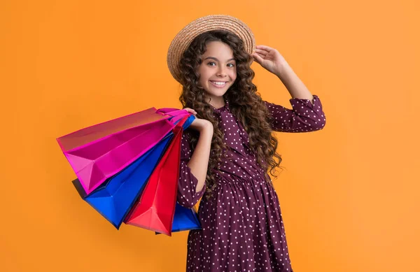 Smiling Child Curly Hair Hold Shopping Bags Yellow Background — ストック写真