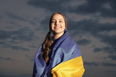 cheerful ukrainian teen girl. teen child with flag. teen kid with flag of ukraine.