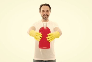 photo of happy man with laundry detergent bottle. man with laundry detergent isolated on white. man with laundry detergent in studio. man with laundry detergent on background.