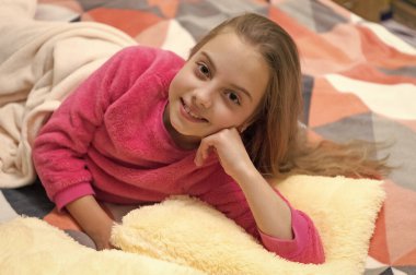childhood of teen girl smile and relax wearing pajama. childhood of teen girl relax. childhood of teen girl relax in bed. childhood of teen girl relax in bedroom.