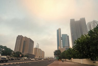 Dubai, United Arab Emirates - December 23, 2017: downtown street road with modern architecture buildings on foggy sky.