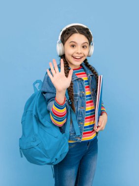 Hello school. Happy teen girl waving hand blue background, school. Back to school. September 1. Knowledge day.