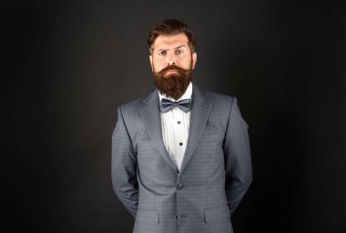 serious man in tuxedo bow tie. gentleman in formalwear on black background. male formal fashion.