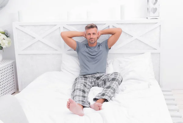 Hes Morning Person Happy Guy Relaxing Bed Putting Hands Head — Stockfoto