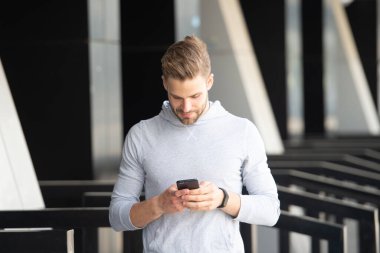 Sporcu telefonda sohbet ediyor. Sporcu caddede telefonda sohbet ediyor. Sporcu dışarıda telefonda sohbet ediyor. Sporcunun telefonda sohbet ederken çekilmiş fotoğrafı..