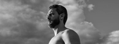 bearded man look far. caucasian man outdoor. man on sky background.