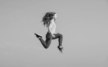 happy teen girl jump high on sky background. vitality.