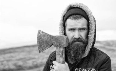 caucasian bearded man lumberjack with axe. photo of bearded man lumberjack holding axe in the mountain. bearded man lumberjack hold axe outdoor. bearded man lumberjack has axe.