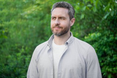 Portrait of handsome professional guy in blue shirt natural background.