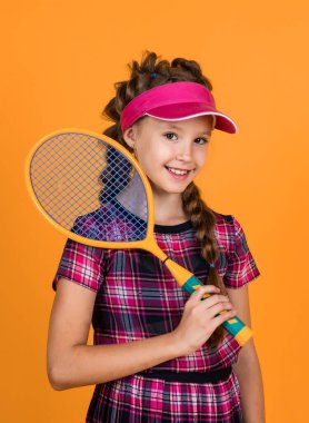 Güzel gülümseme. Tenisçi çocuk. Okula dönüyorum. Mutlu ve sağlıklı bir çocukluk. aktif yaşam tarzı. Spor oyunları oynuyorum. aktivite. Spor giyim sektöründe neşeli bir genç kız. çocuk tutun badminton raketi.