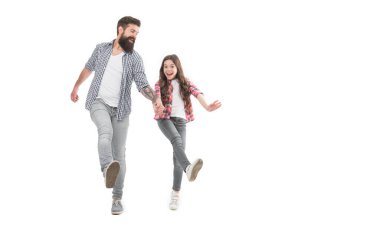 Unstoppable. Energetic daughter and father walk holding hands. Happy family in energetic mood. Photo shoot in studio. Staying energetic and positive. Enjoy fun. Feel pleasure. Energetic and active.