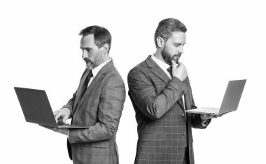 pondering businessmen freelance isolated on white background. businessmen freelance in studio. photo of businessmen freelance with laptop. two businessmen freelance using laptop.