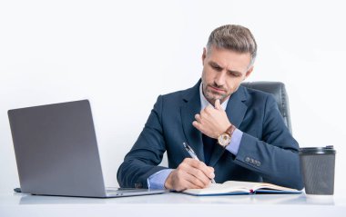 Olgun işverenin iş yerindeki masada yazı yazması.