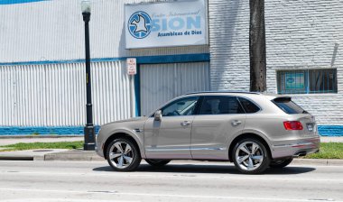 Miami Beach, Florida USA - April 15, 2021: silver Bentley Bentayga v8 2015 suv, back side view.