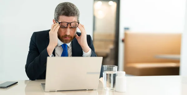 stock image photo of man manager has pain and fatigue, copy space. man manager has pain and fatigue in office. man manager has pain and fatigue while working. man manager has pain and fatigue.