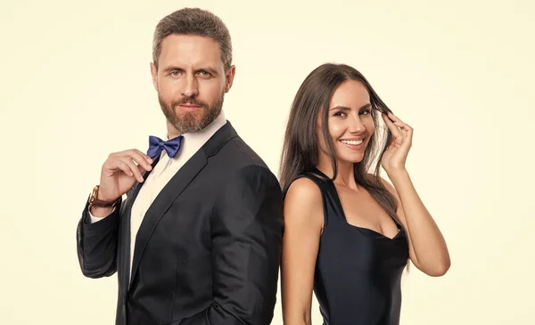 stock image happy couple in formal tuxedo. studio shot of formal tuxedo couple. elegant couple wear formal tuxedo. formal tuxedo couple isolated on white background.