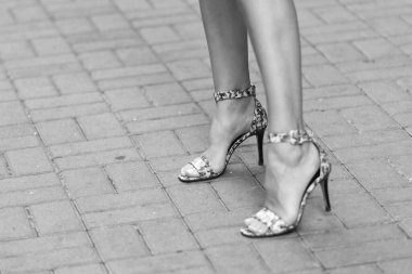 footwear of heel shoes on legs, selective focus. footwear of heel shoes outdoor. female footwear of heel shoes. footwear of heel shoes fashion.