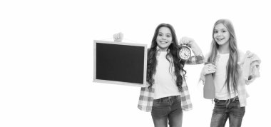 Her şeyin bir zamanı vardır. Görevdeki küçük kızlar mutlu bir şekilde sırıtıyor. Düzenli bir kara tahta ve çalar saatle. Zaman kavramı. Çalışma ve çalışma zamanı. Zamanınızı etkili bir şekilde yönetin, boşluğu kopyalayın.