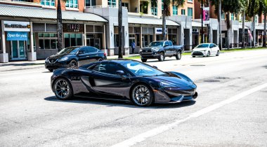 Miami Beach, Florida USA - April 15, 2021: mclaren exclusive 570GT MSO Black, side corner view.