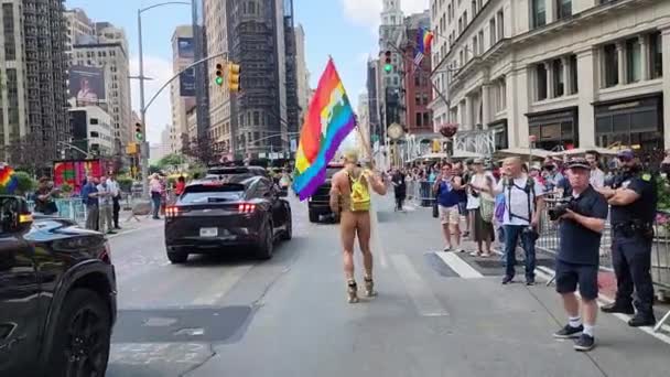 ニューヨーク 2023年6月25日 ニューヨークでのプライド行進パレード2023年 プライド虹色のLgbtの旗の平和を持つ男ゲイ LgbtとLgbtqのパレード 動画クリップ