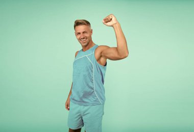 glad sport athlete making winning gesture. Athlete winner blue background. sport man celebrating victory, athlete.