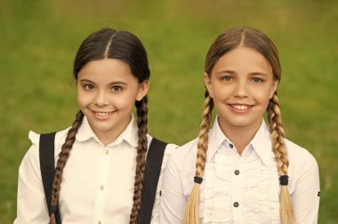 schoolgirl portrait. two positive teen children schoolgirls outdoor. friendship of schoolgirls.