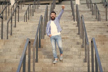 bearded guy walk downstairs. full length of successful guy with beard. hipster guy outdoor at stairs.