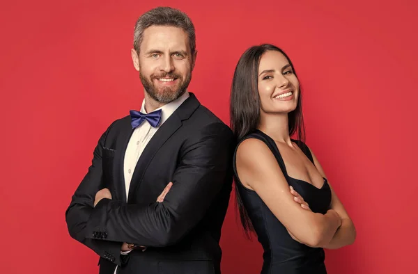 stock image studio shot of glad formal tuxedo couple. elegant couple wear formal tuxedo. formal tuxedo couple isolated on white background. couple in formal tuxedo.