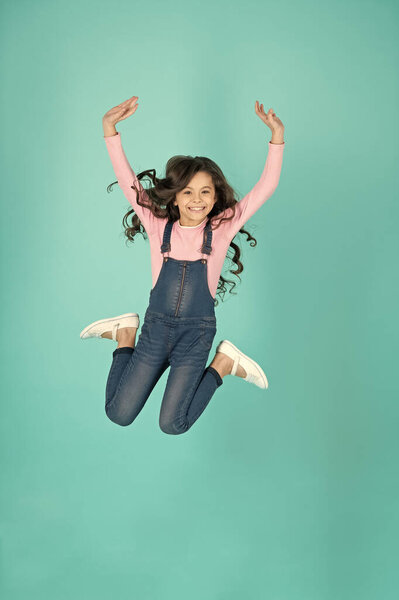 childhood of teen girl jumping on background. childhood of teen girl. childhood of teen girl isolated on blue. childhood of teen girl in studio.